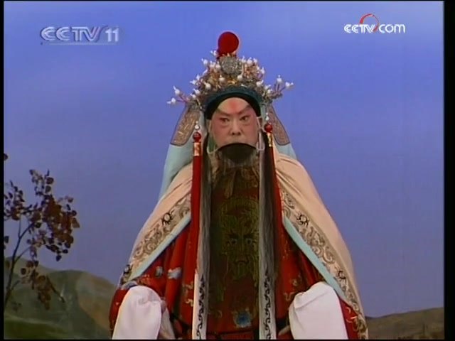 央视《名段欣赏》所播京剧《沙桥饯别》选段录像截帧：汪正华演唱（王帽红蟒、黑三髯老生扮相）