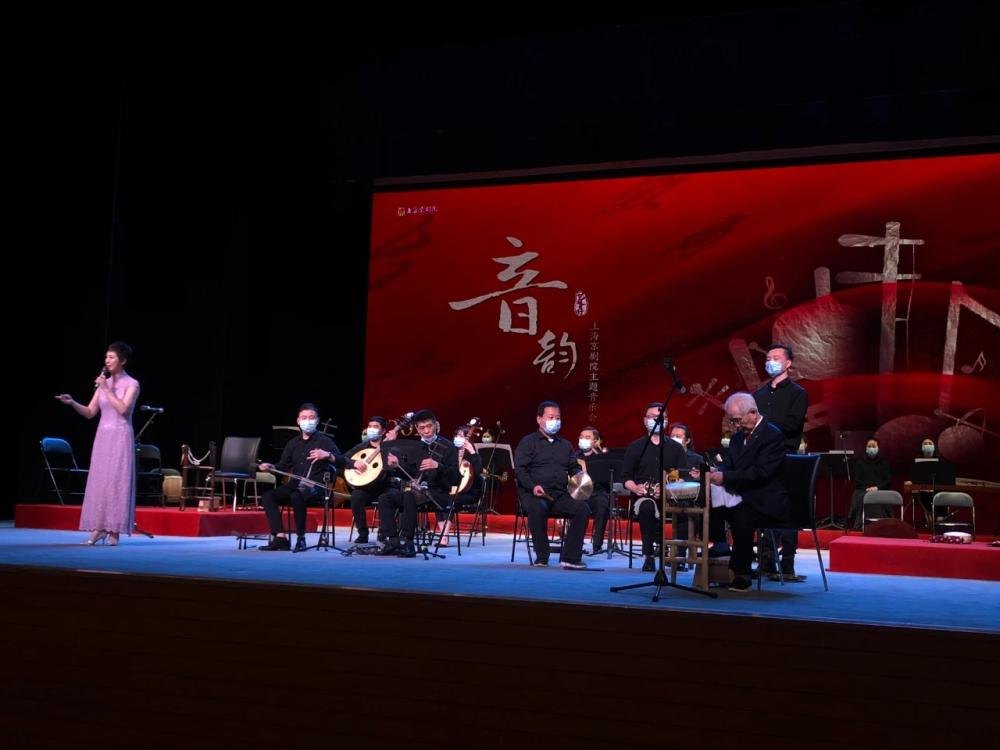 王玉璞（右）在音乐会舞台上司鼓，民族乐队于台上伴奏